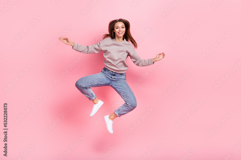 Full body photo of satisfied glad lady jumping have good mood isolated on pink color background