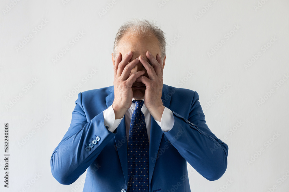 Portrait of stressed mature businessman covering face with hands. Senior manager wearing formalwear crying or having problem. Trouble or problem concept Portrait of stressed mature businessman covering face with hands. Senior manager wearing formalwear crying or having problem. Trouble or problem concept