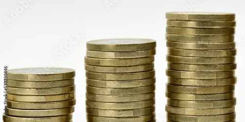 Pilas de monedas de euro dispuestas de mayor a menor, aislado en blanco