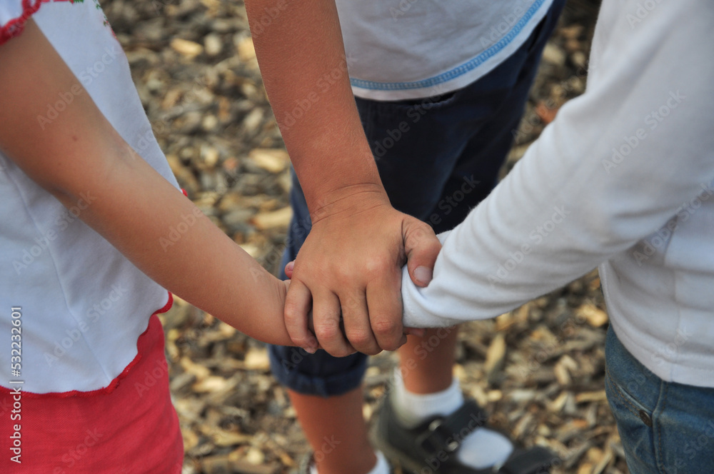 Friendship. Children hold hands as a sign of reconciliation.