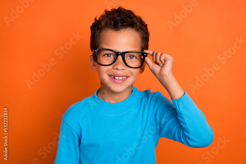 Φωτογραφία Close up photo of positive cute boy hand touch eyeglasses like new accessory wea