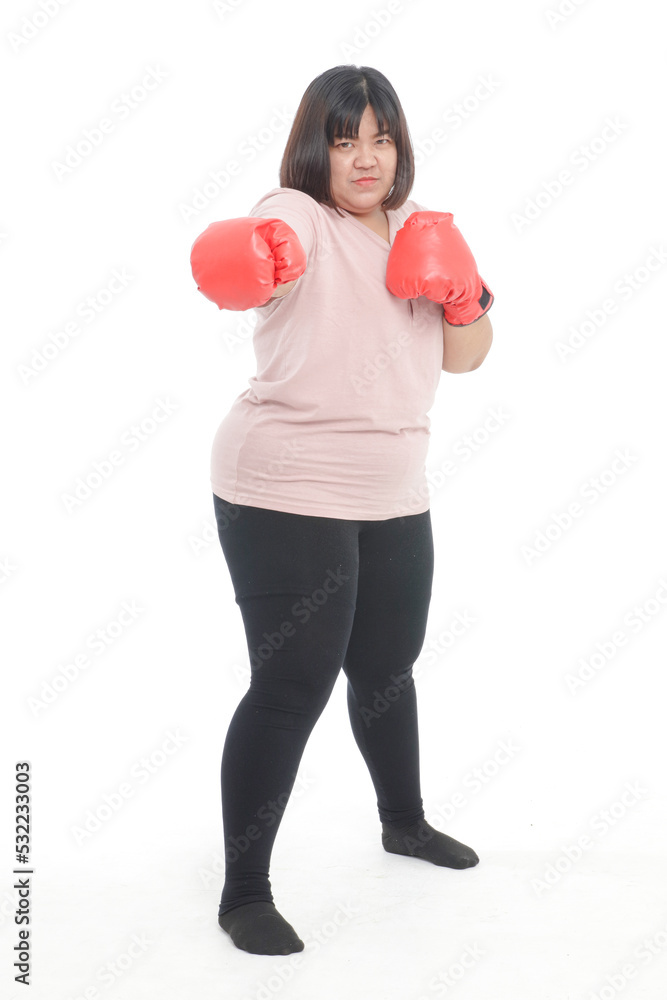 Fat Asian woman wearing red boxing gloves to exercise to lose weight stand on a white background. fitness concept Fat Asian woman wearing red boxing gloves to exercise to lose weight stand on a white background. fitness concept