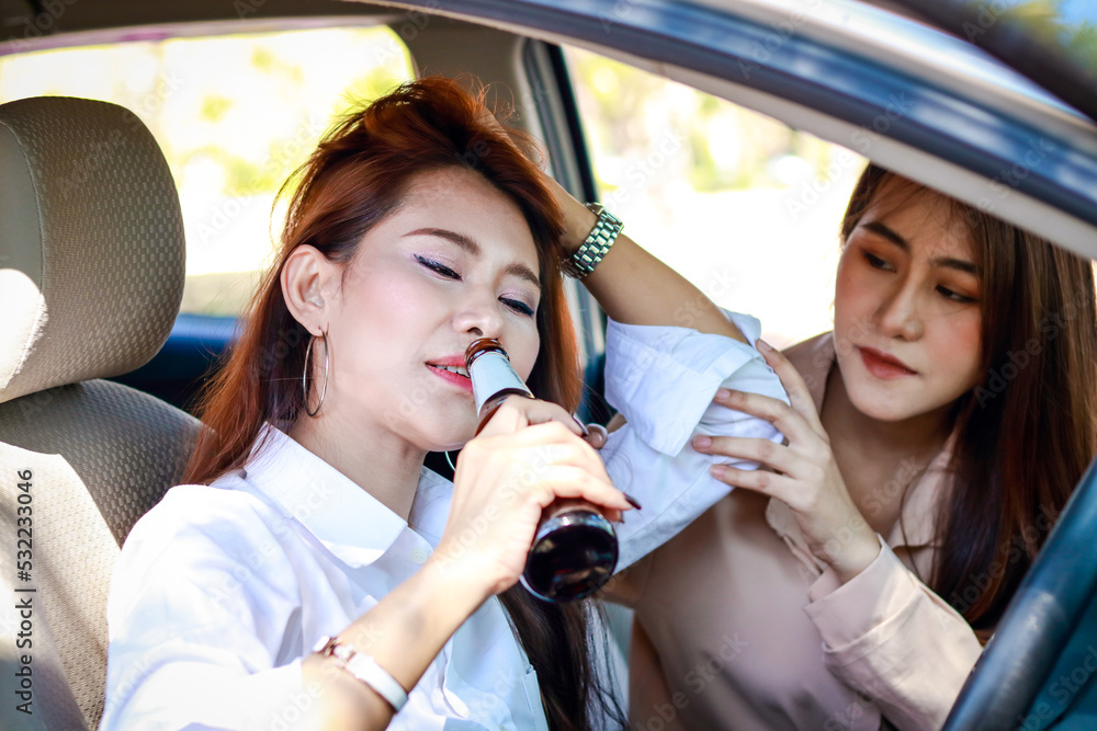 Two young women drink alcohol in their private cars. There is a risk of driving an accident. Transportation concept.