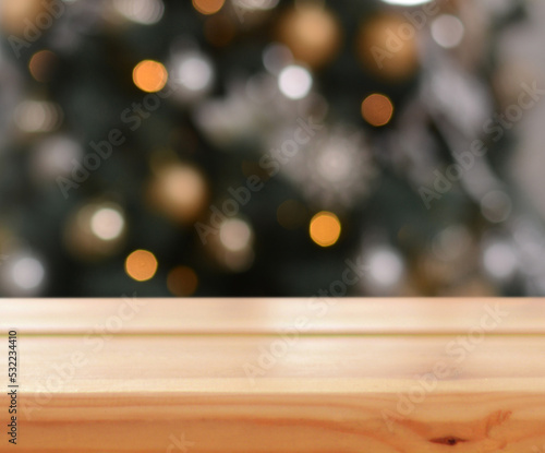 Christmas background. Empty wooden table on the background of the Christmas tree and New Year s bokeh.Ready for product montage. Merry Christmas and Happy New Year  Mockup