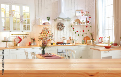 Empty wooden table on background of light christmas kitchen in scandinavian style. Christmas background. Ready for product montage.Merry Christmas and Happy New Year! Banner.Mockup.