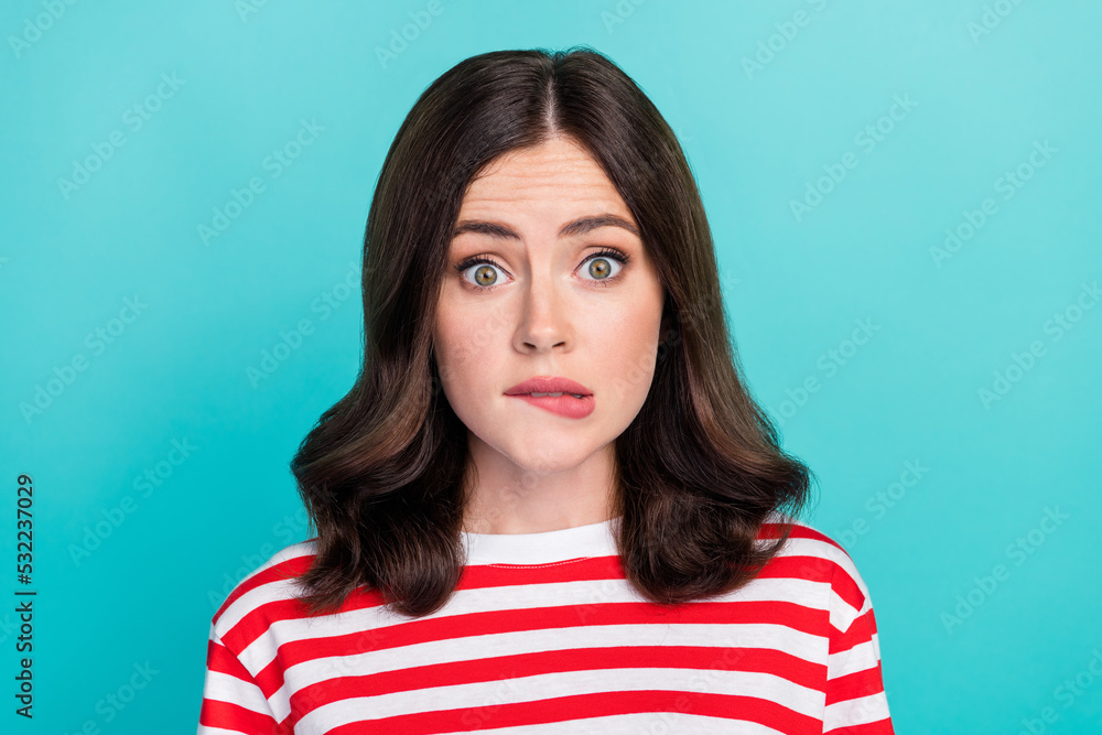 Fototapeta premium Closeup photo of young adorable cute girlish lady wear striped red t-shirt bite lips nervous unhappy sorry failed isolated on aquamarine color background