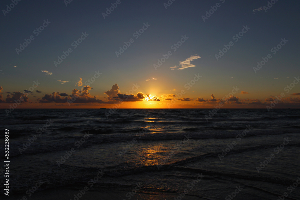 beautiful tropical sunrise with clouds and sunset on the sea