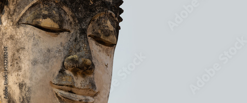 Obraz na płótnie Close-up of the face of an ancient Buddha statue in a temple in Sukhothai Histor
