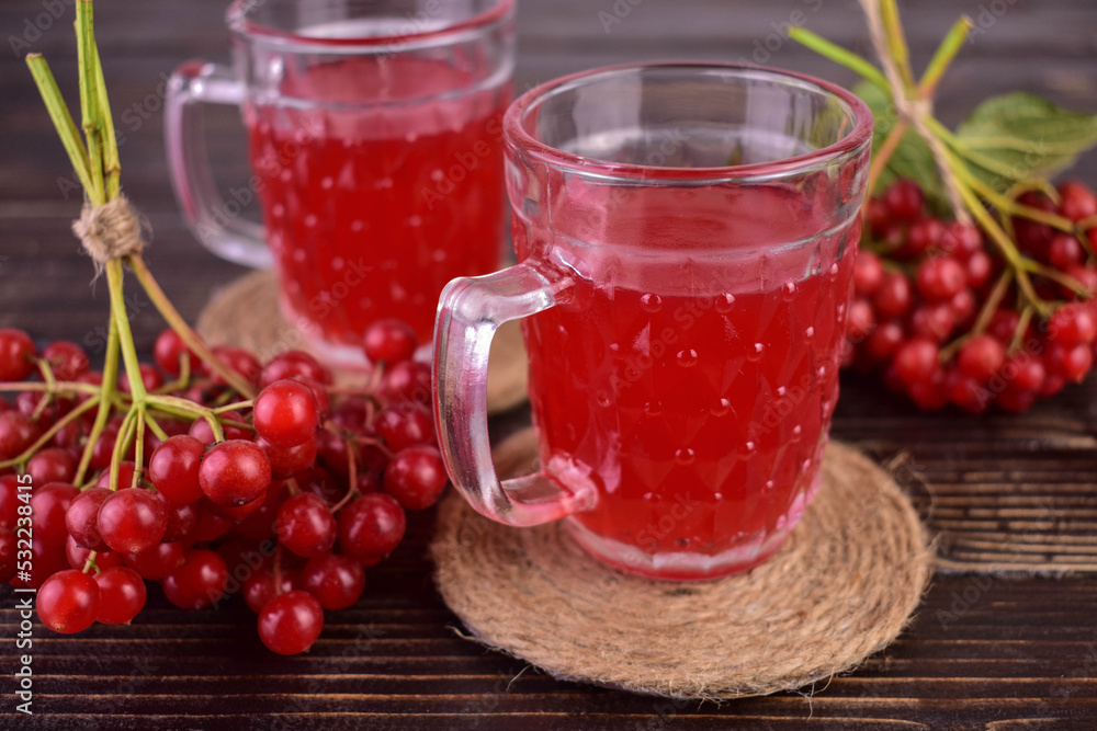 Useful tea from viburnum berries and on a dark wooden background.
Useful tea from viburnum berries and on a dark wooden background.