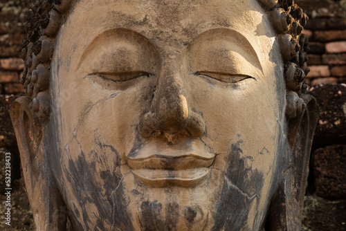 Canvas Print Close-up of the eye and face of an ancient Buddha statue in a temple in Sukhotha