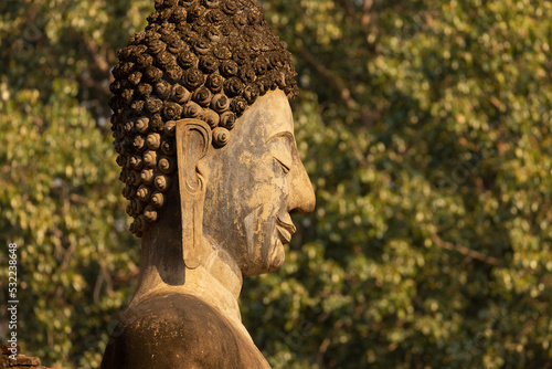 Photography Close-up of the profile face of a Buddha statue in a temple in Sukhothai Histori