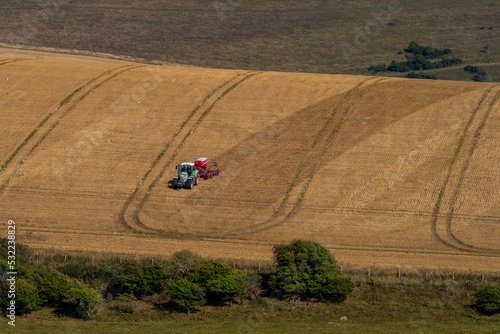 Tractor working in fields on the Sussex Downs in late summer.