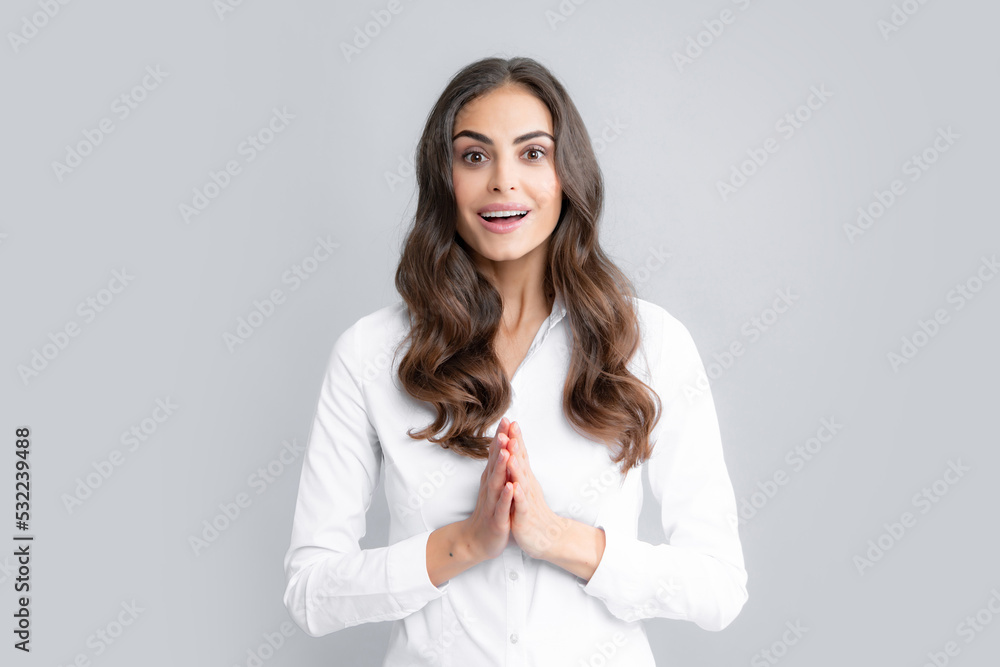 Pretty woman dressed casually in shirt looking with satisfaction. Studio shot of beautiful woman isolated against gray background. Excited female model. Pretty woman dressed casually in shirt looking with satisfaction. Studio shot of beautiful woman isolated against gray background. Excited female model.