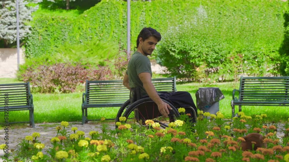 Disabled young man driving his wheelchair touches flowers.
Young disabled man walking on the street touching flowers.
Disabled young man driving his wheelchair touches flowers.
Young disabled man walking on the street touching flowers.