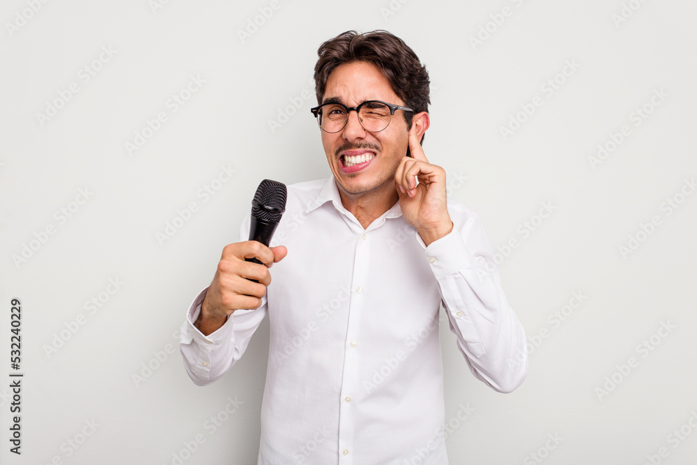 Young hispanic singer man isolated on white background covering ears with hands.