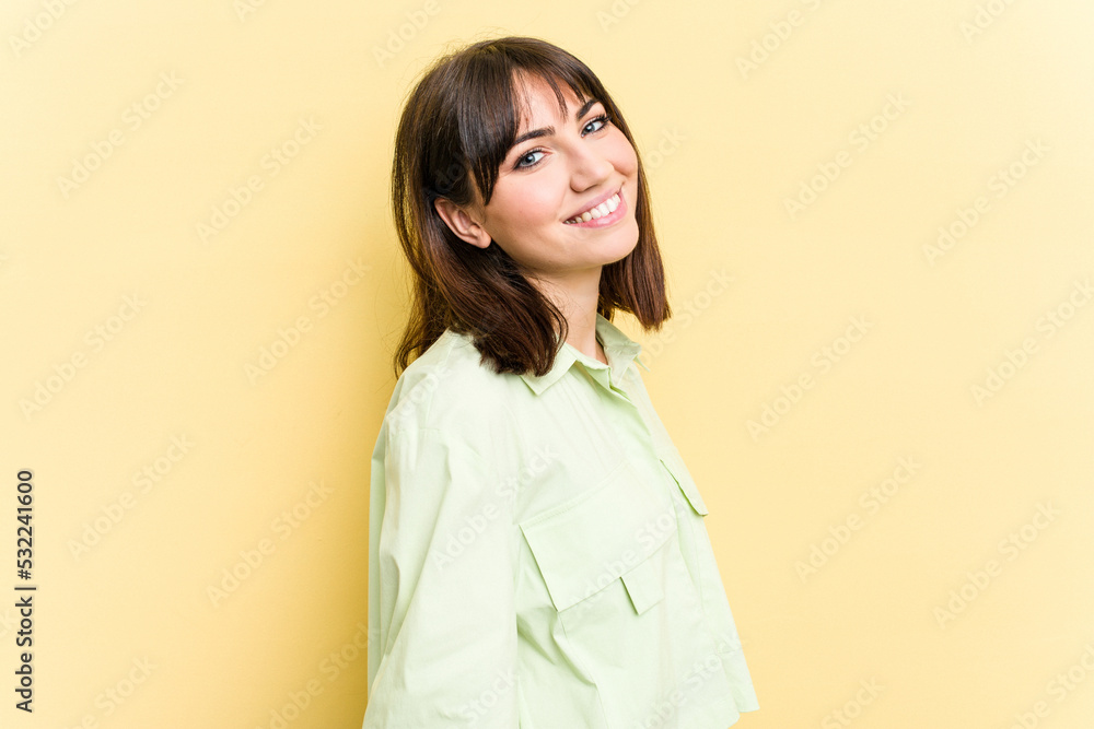 Young caucasian woman isolated on yellow background confident keeping hands on hips. Young caucasian woman isolated on yellow background confident keeping hands on hips.