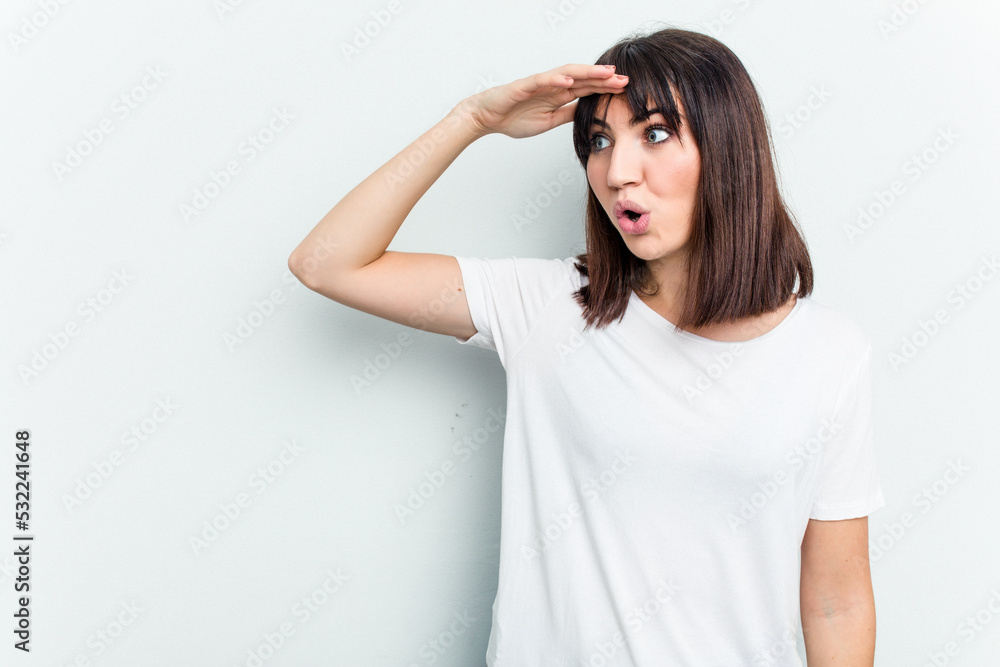 Young caucasian woman isolated on white background looking far away keeping hand on forehead. Young caucasian woman isolated on white background looking far away keeping hand on forehead.
