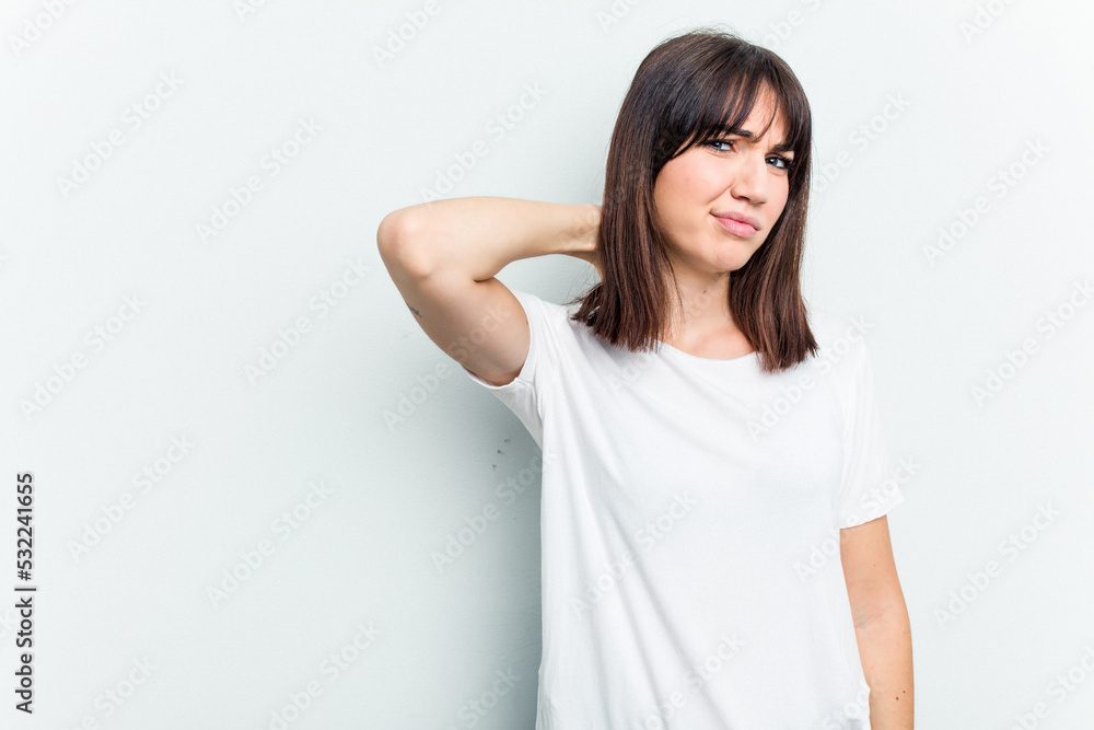 Young caucasian woman isolated on white background touching back of head, thinking and making a choice. Young caucasian woman isolated on white background touching back of head, thinking and making a choice.