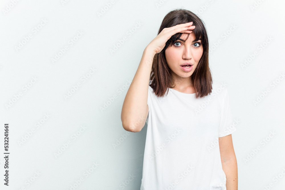 Young caucasian woman isolated on white background shouts loud, keeps eyes opened and hands tense. Young caucasian woman isolated on white background shouts loud, keeps eyes opened and hands tense.