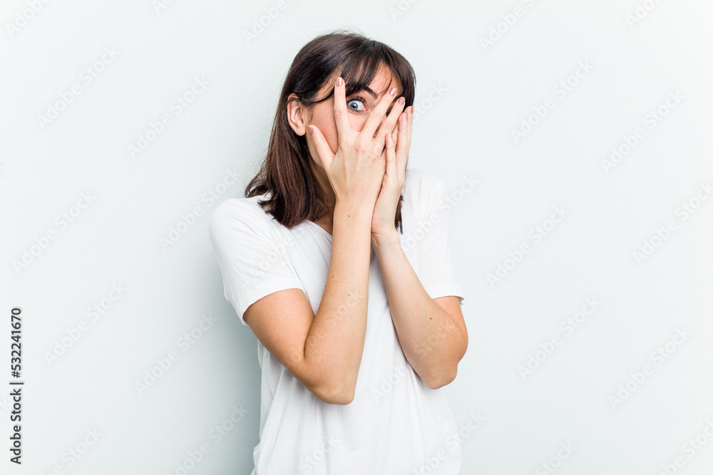 Young caucasian woman isolated on white background blink through fingers frightened and nervous. Young caucasian woman isolated on white background blink through fingers frightened and nervous.