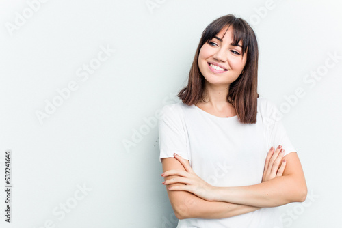 Young caucasian woman isolated on white background smiling confident with crossed arms.