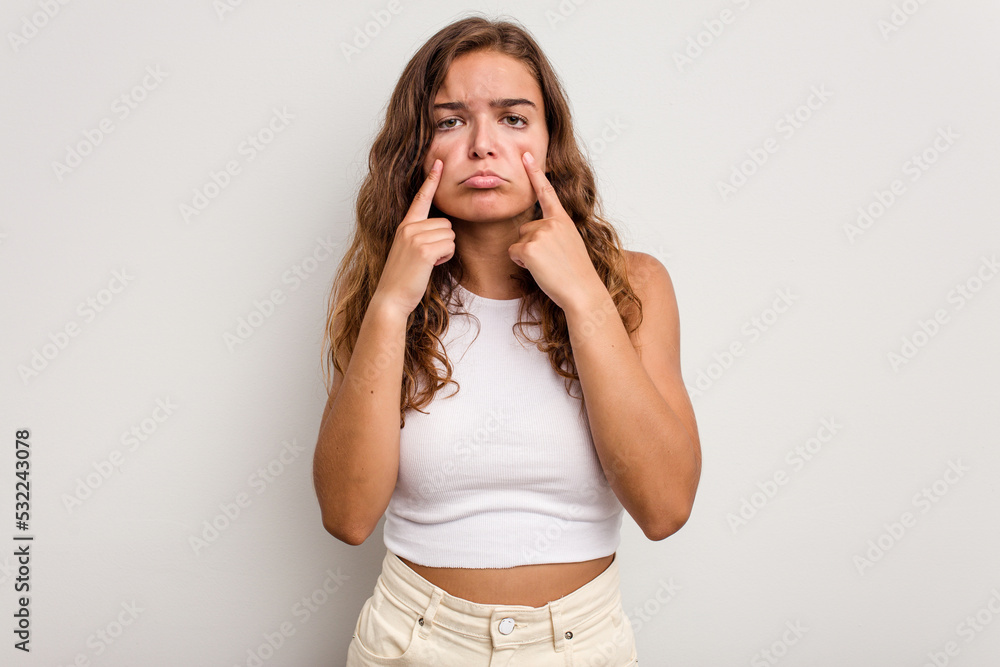 Young caucasian woman isolated on blue background crying, unhappy with something, agony and confusion concept. Young caucasian woman isolated on blue background crying, unhappy with something, agony and confusion concept.