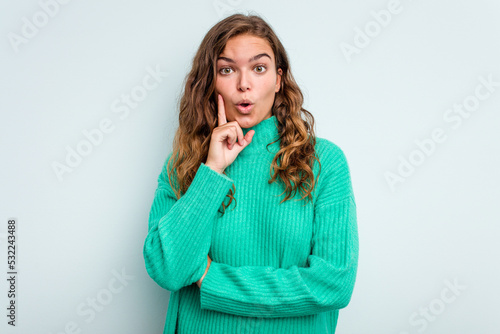 Young caucasian woman isolated on blue background having some great idea, concept of creativity.
