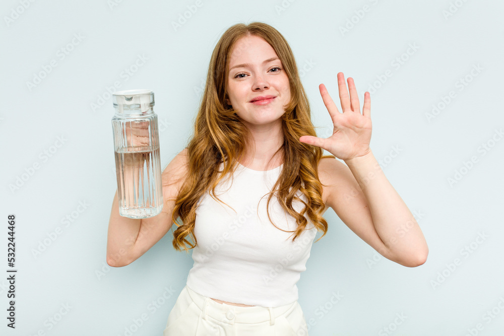 Young caucasian woman holding jar of water isolated on blue background smiling cheerful showing number five with fingers. Young caucasian woman holding jar of water isolated on blue background smiling cheerful showing number five with fingers.