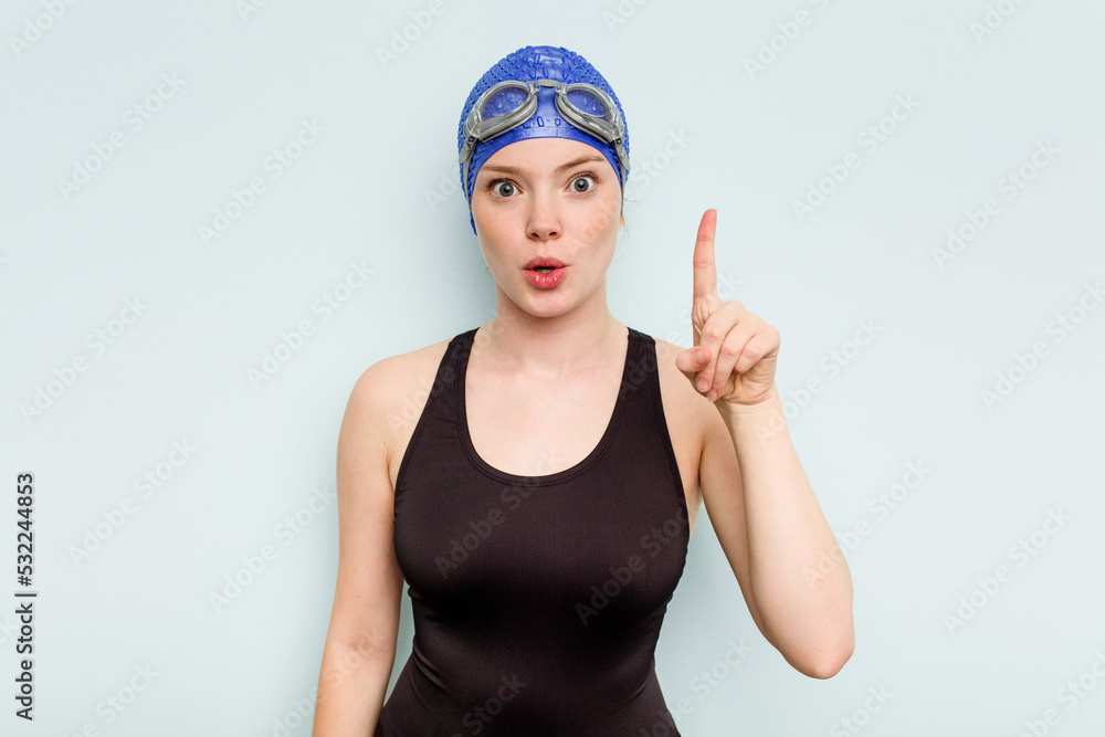 Young caucasian swimmer woman isolated on blue background having some great idea, concept of creativity. Young caucasian swimmer woman isolated on blue background having some great idea, concept of creativity.