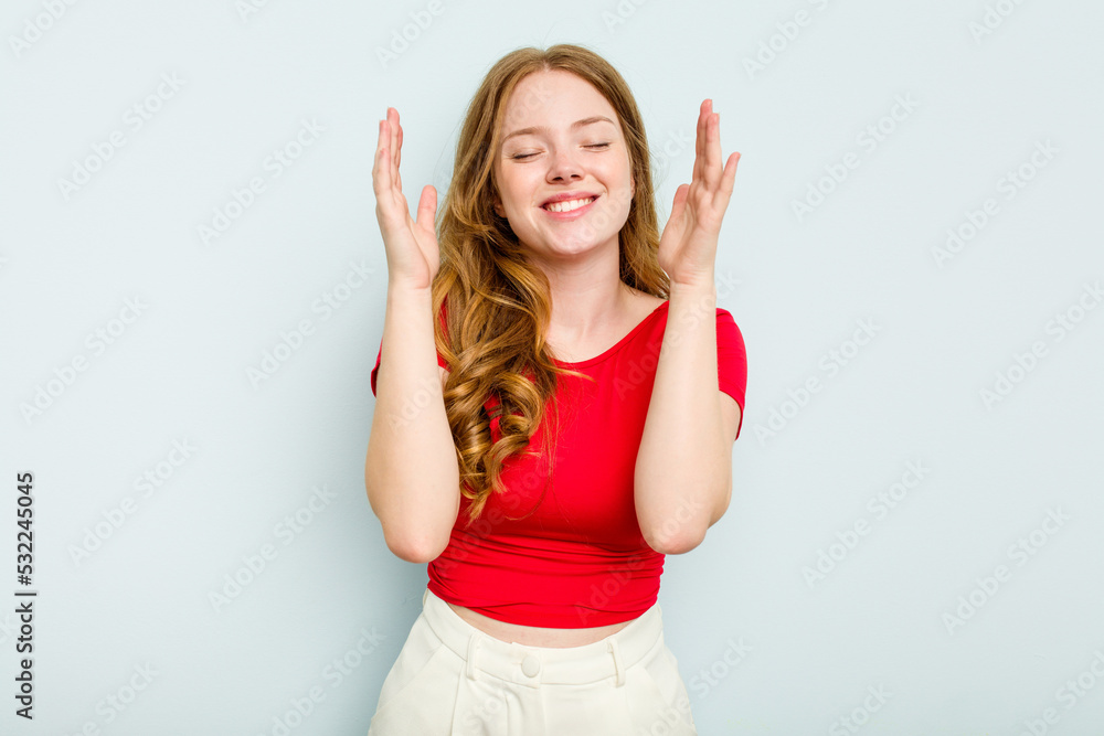 Young caucasian woman isolated on blue background joyful laughing a lot. Happiness concept. Young caucasian woman isolated on blue background joyful laughing a lot. Happiness concept.