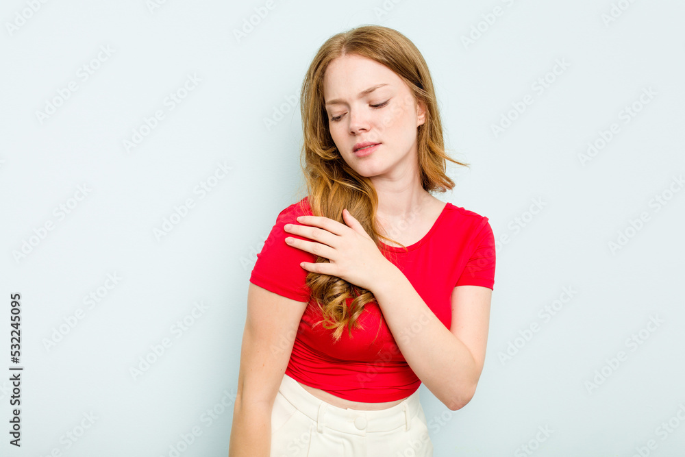 Young caucasian woman isolated on blue background having a shoulder pain. Young caucasian woman isolated on blue background having a shoulder pain.