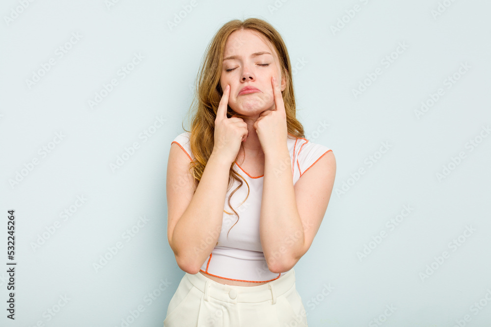 Young caucasian woman isolated on blue background crying, unhappy with something, agony and confusion concept. Young caucasian woman isolated on blue background crying, unhappy with something, agony and confusion concept.