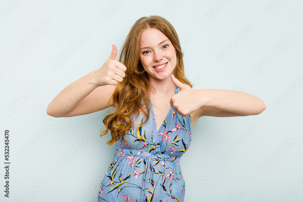 Young caucasian woman isolated on blue background raising both thumbs up, smiling and confident. Young caucasian woman isolated on blue background raising both thumbs up, smiling and confident.