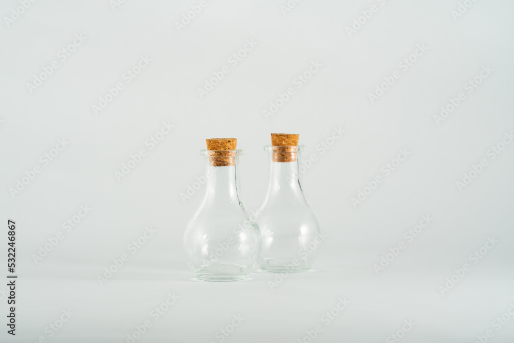 small glass bottles isolated in front of white backdrop small glass bottles isolated in front of white backdrop