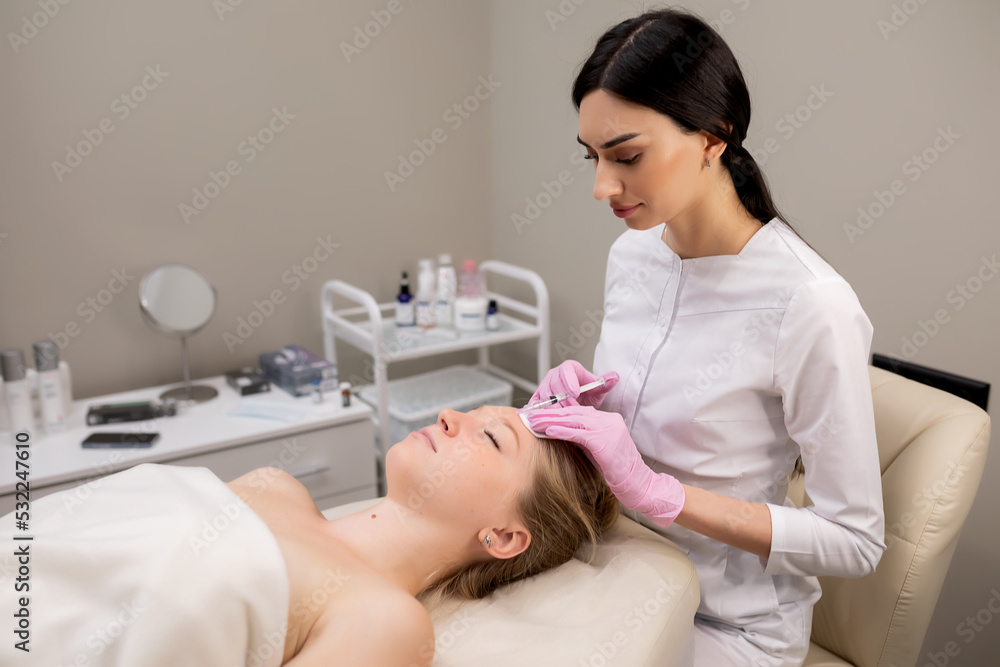 Cosmetologist gives a facial massage to a girl in the salon.Spa concept relaxation and self-care. Cosmetologist gives a facial massage to a girl in the salon.Spa concept relaxation and self-care.