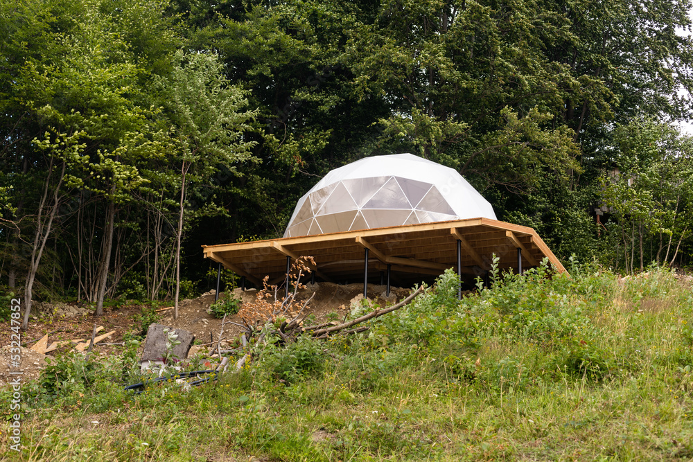 White Tent Geosphere in the Forest Cozy Camping Glamping Vacation Lifestyle Concept Outdoors Cabin