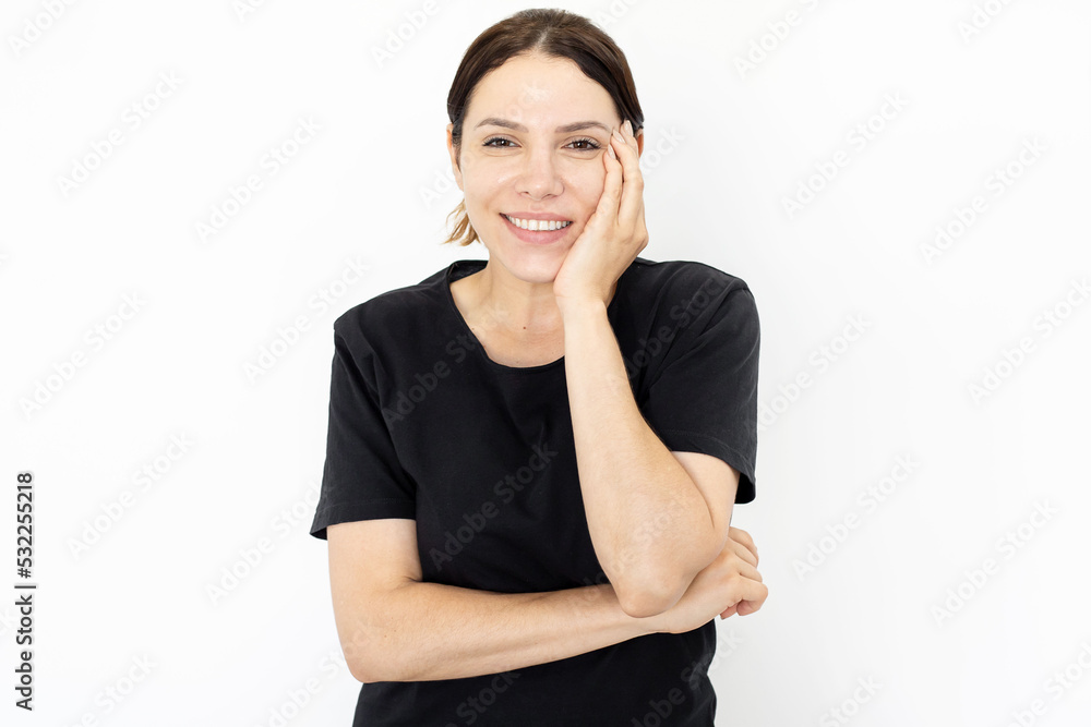Happy woman gesturing and smiling at camera. Front view of pretty Caucasian woman in black T-shirt posing for camera, standing on white background. Emotion, expression, studio shot, happiness concept Happy woman gesturing and smiling at camera. Front view of pretty Caucasian woman in black T-shirt posing for camera, standing on white background. Emotion, expression, studio shot, happiness concept