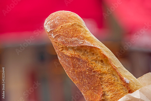 French baguette against blurred street of Paris