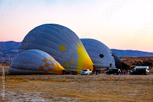 inflate balloons before flying in the pink sky before sunrise