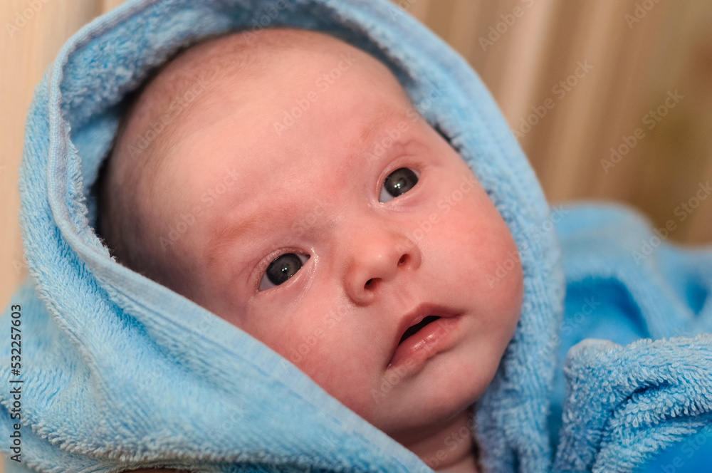 baby in a pink cap and with a pacifier