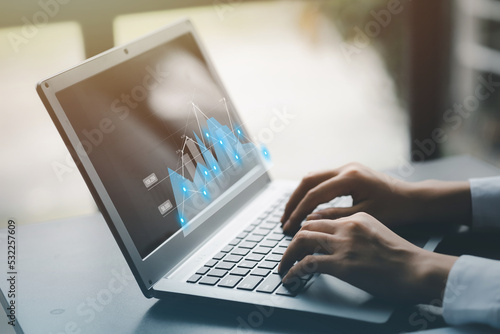 A businessman examines data on financial documents, company financial reports, graphics showing financial and numerical growth data. The concept of financial management to grow and be profitable.