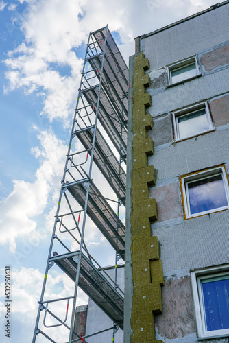 Thermal insulation of the facade of an apartment building with thick mineral rock wool slabs