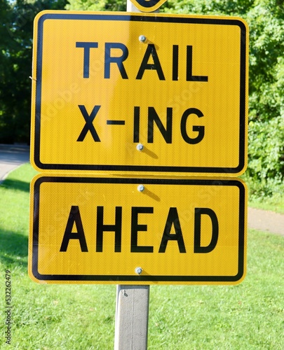 A close view of the yellow trail crossing sign