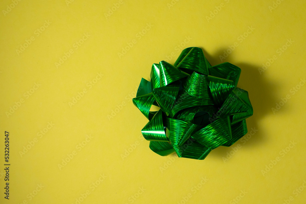top view green gift bow yellow background with colored bow