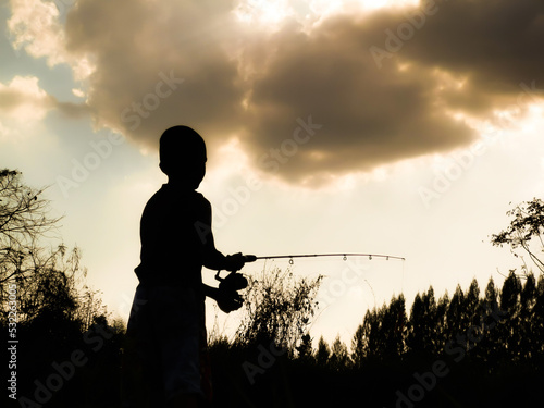 silhouette of a child fishing children s happy time in the