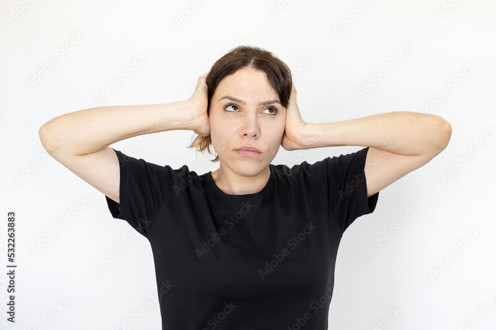 Woman rolling her eyes and covering hear ears with hands. Caucasian woman having no desire to listen conversation, unsolicited advice or opinion. Negative emotion, expression, gesture concept Woman rolling her eyes and covering hear ears with hands. Caucasian woman having no desire to listen conversation, unsolicited advice or opinion. Negative emotion, expression, gesture concept