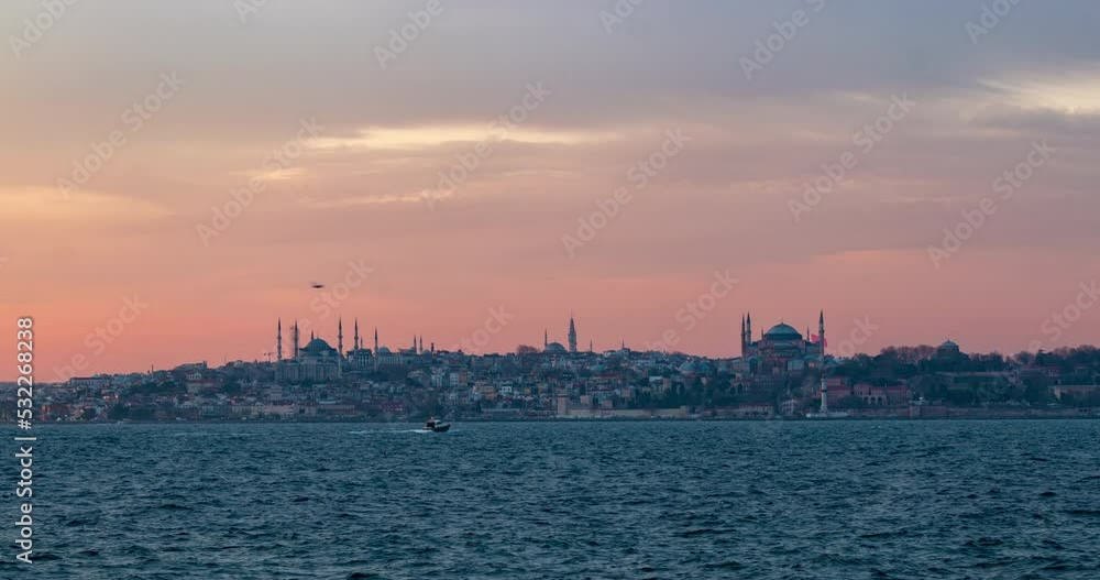 Day to night sunset timelapse of Istanbul city riverside bay traffic dock with mosques on the background Day to night sunset timelapse of Istanbul city riverside bay traffic dock with mosques on the background