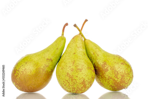 Three juicy green pears, macro, isolated on a white background.