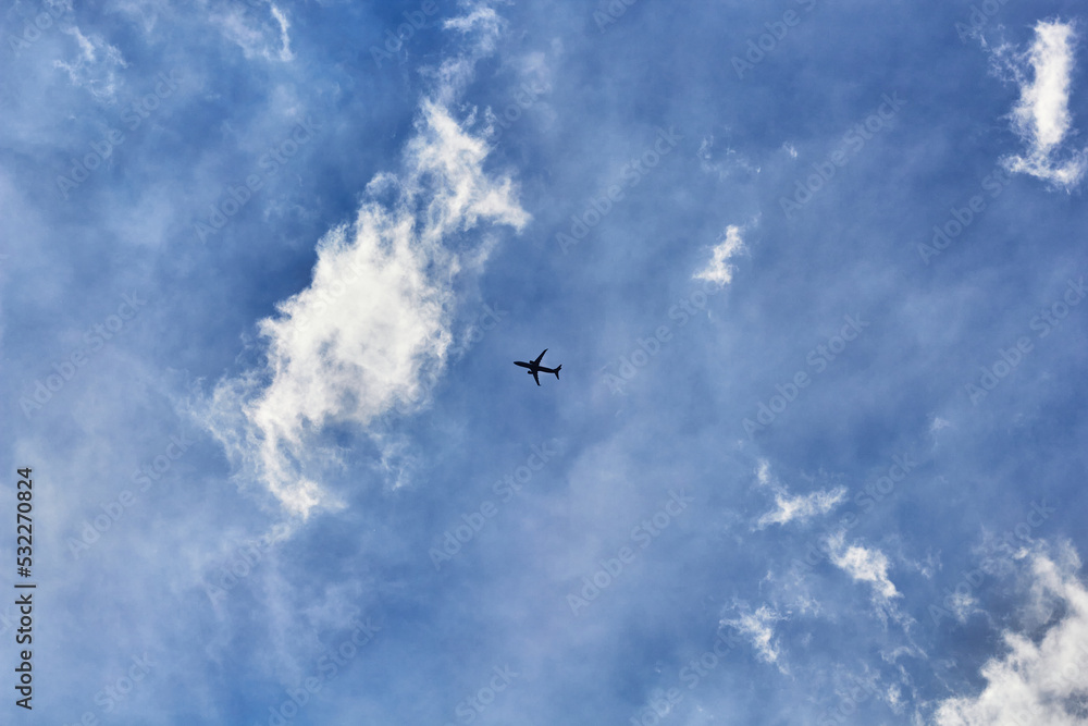 Airplane flying, blue sky, white clouds Airplane flying, blue sky, white clouds