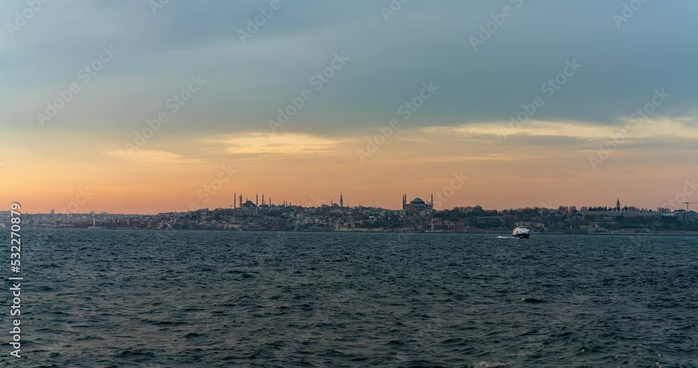 Day to night sunset timelapse of Istanbul city riverside bay traffic dock with mosques on the background Day to night sunset timelapse of Istanbul city riverside bay traffic dock with mosques on the background